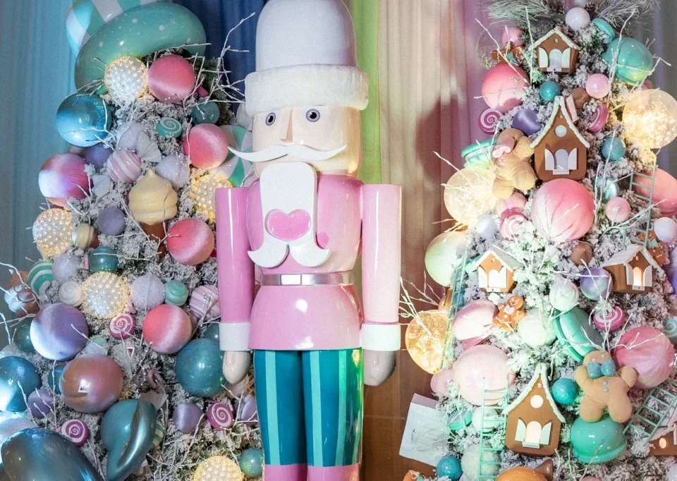 Sala pastel con cascanueces rosa, árboles de dulces y regalos